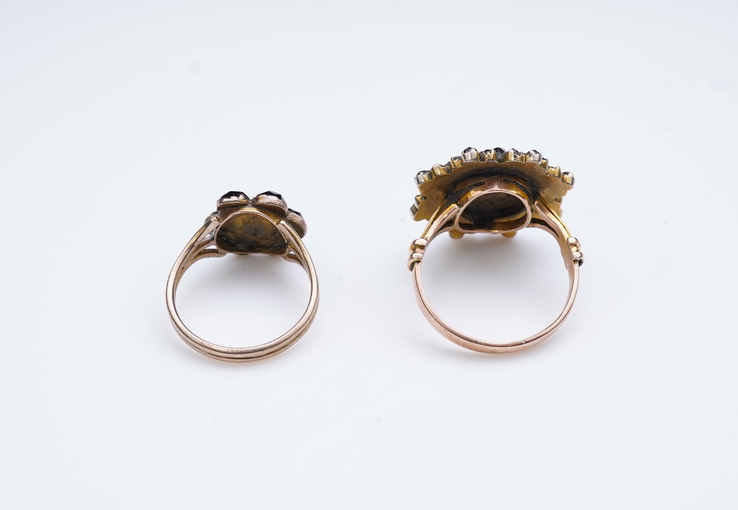 A suite of garnet and paste jewellery, comprising: a brooch, 5cm diameter; a bangle, inner circumference 16cm; two rings, sizes I and M; a pair of earrings, and a single earring, each set with rose-cut garnets; and a pai